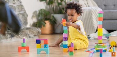 Child stacking blocks from The Block Set by Lovevery